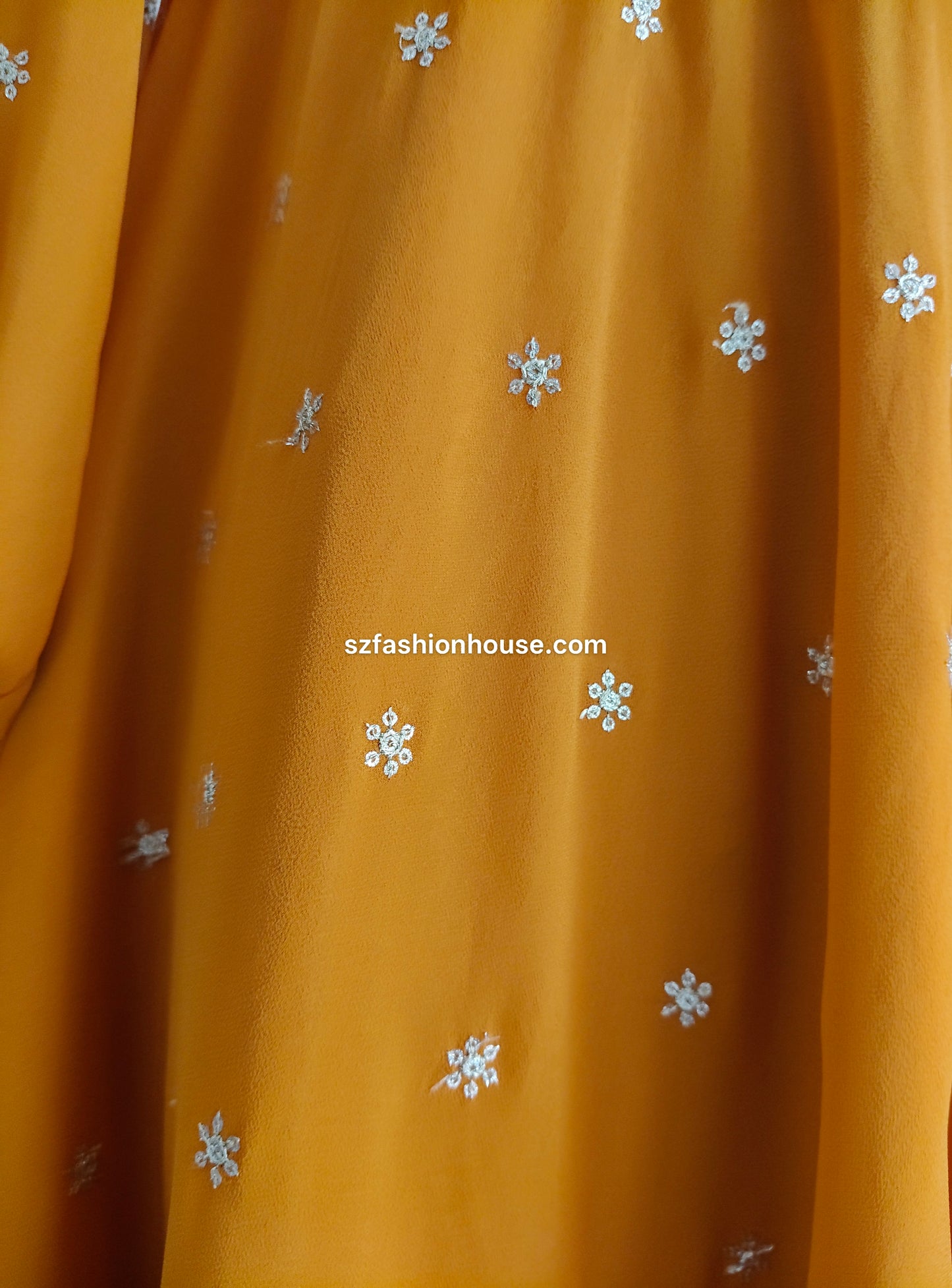 Fabric with small white floral patterns, featuring 'szfashionhouse.com' branding.