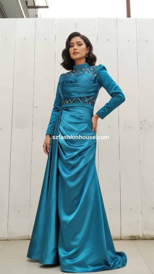 Woman wearing a blue evening gown with intricate detailing