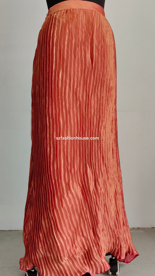 Long pleated skirt with a textured pattern on a plain background