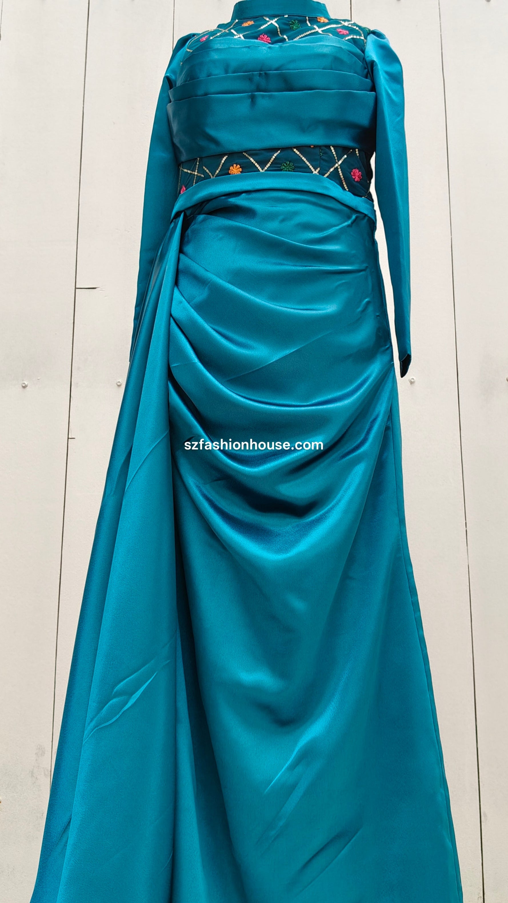 Teal evening gown with a fitted bodice and flowing skirt 