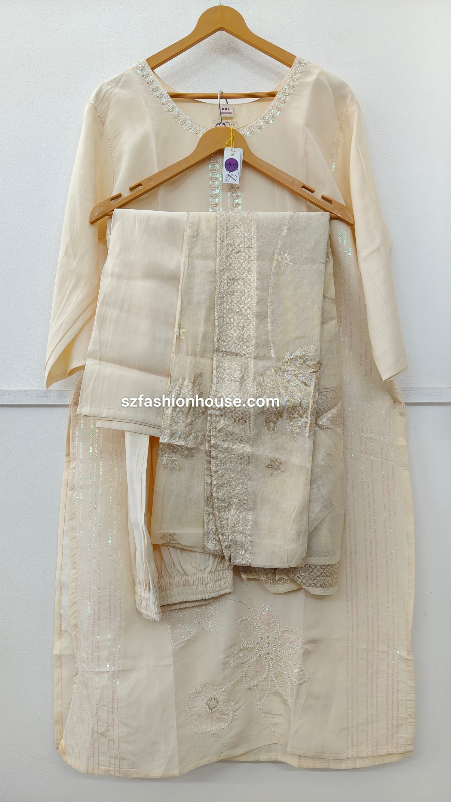 Beige traditional outfit with embroidered details 