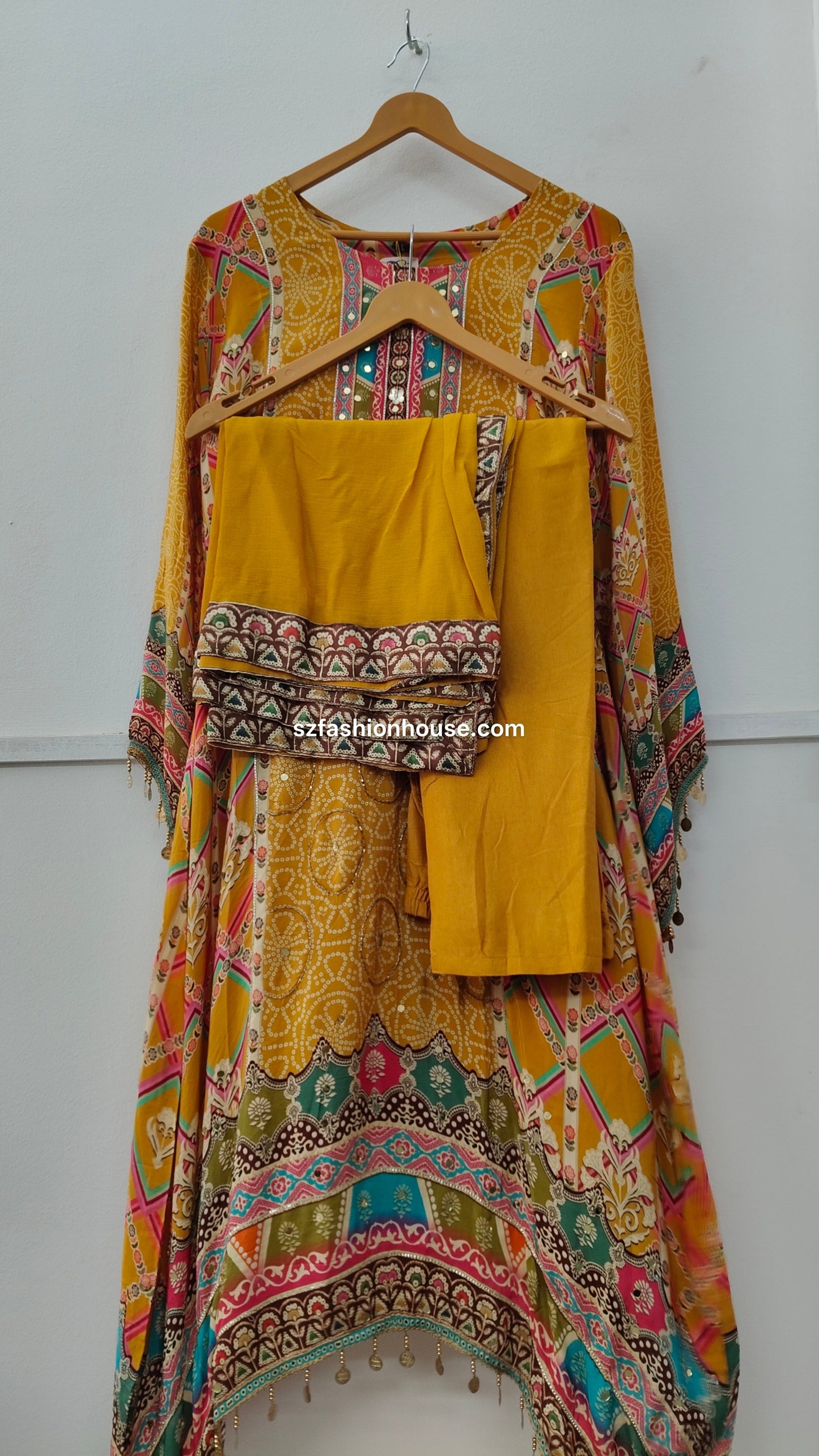 Colorful traditional outfit with a patterned top and yellow dupatta 